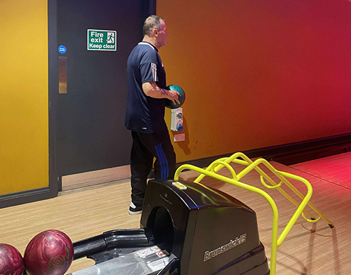 A photograph of a resident bowling
