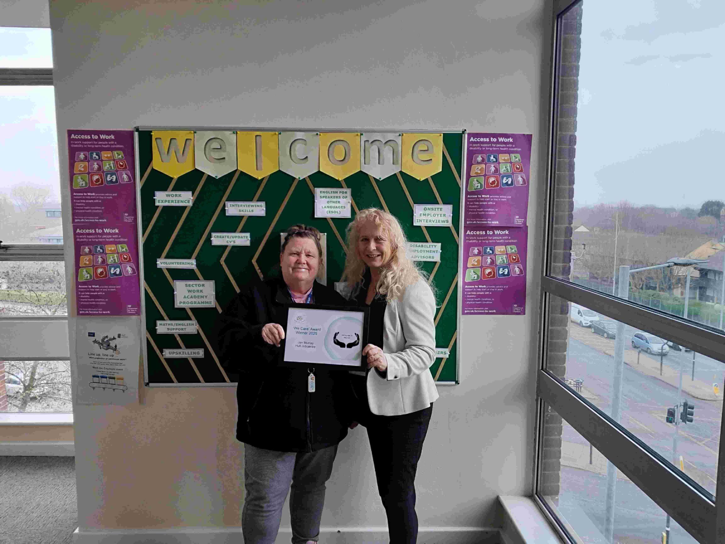 A photograph of Janine Murray receiving her We Care award.
