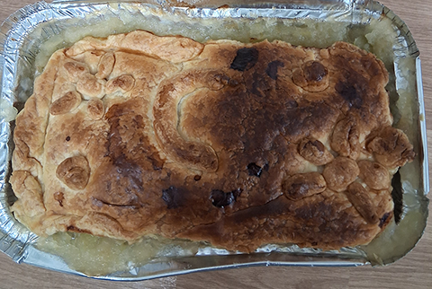A photograph of one of the items baked, a pie with a C baked into it