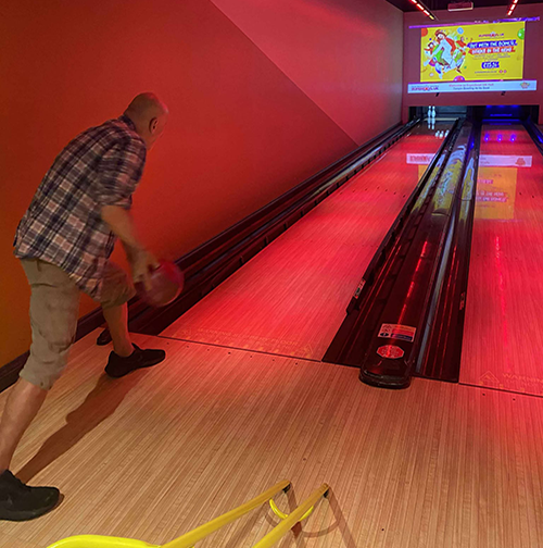 A photograph of a resident bowling
