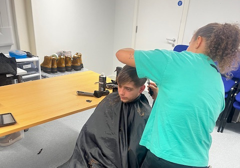 An attendee getting their haircut at the Changing Futures hub