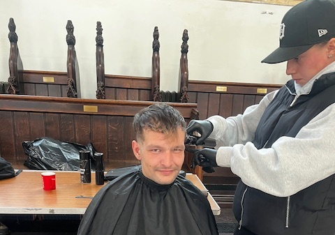 One of the attendees getting a free haircut