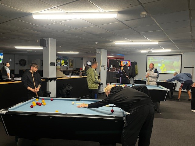 A photograph of the pool tournament taking place